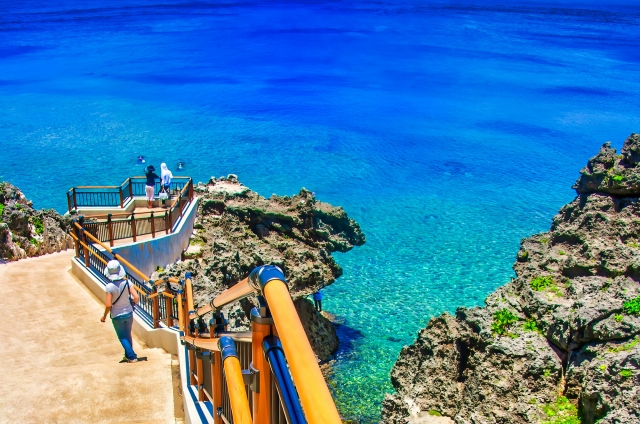 The staircase and platform above bright blue water at Cape Maeda